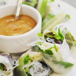 Close-up of rice paper rolls served with sauce in plate