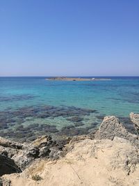 Scenic view of sea against clear blue sky