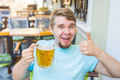 Portrait of a smiling man drinking glass