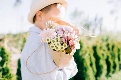 Close-up of woman holding white flower