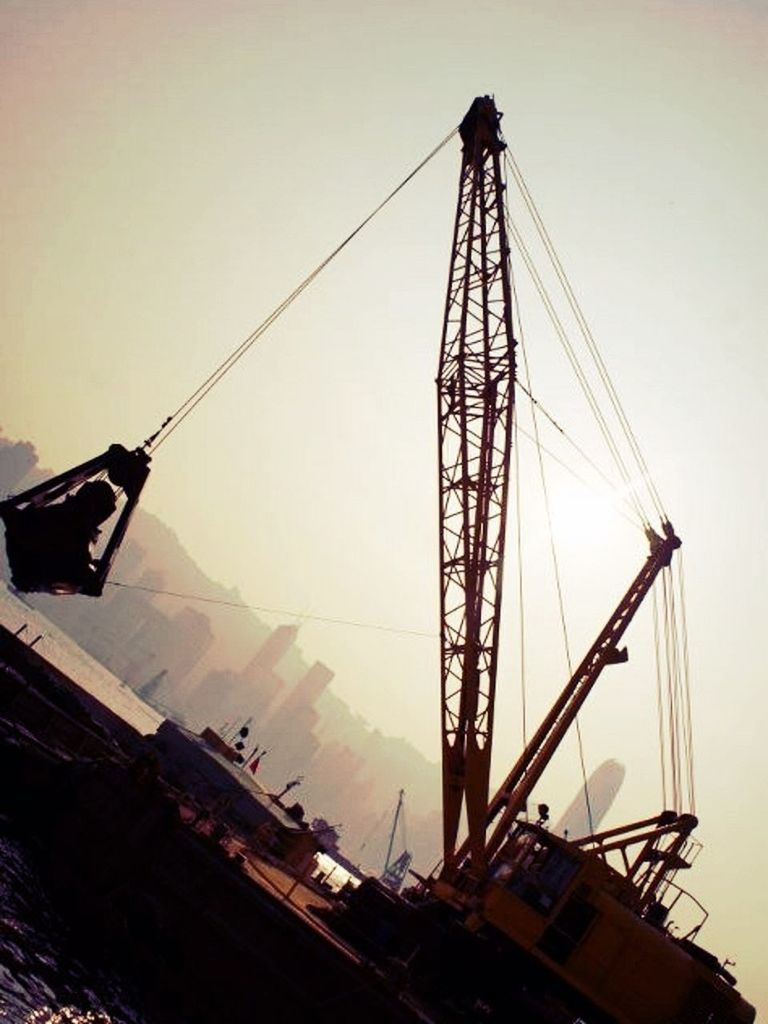 low angle view, sky, clear sky, transportation, nautical vessel, mode of transport, crane - construction machinery, mast, construction site, built structure, outdoors, fuel and power generation, silhouette, development, no people, technology, construction, boat, connection, dusk