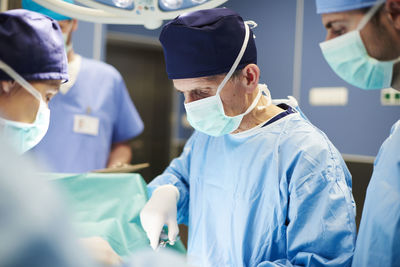 Doctors operating patient in emergency room