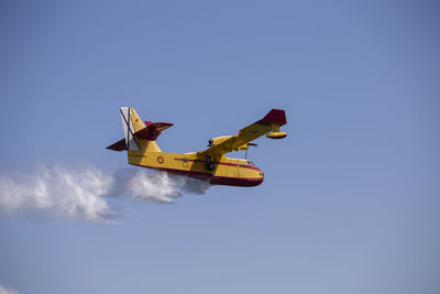 Low angle view of airplane flying in sky