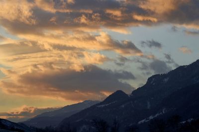 Scenic view of snowcapped mountains against sky during sunset