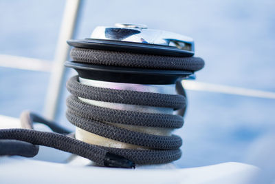 Close-up of rope tied to bollard against sky