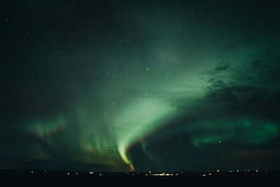 Low angle view of illuminated buildings against sky at night