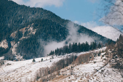 Panoramic shot of mountains against sky during winter