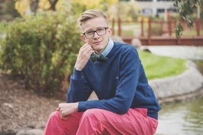 Portrait of young man sitting outdoors