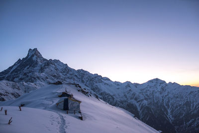 Scenic view of snowcapped mountains against clear sky