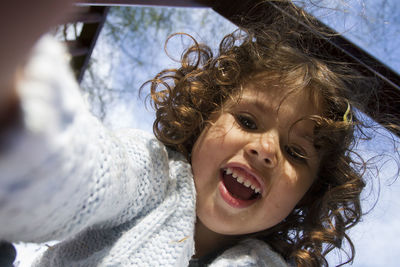 Low angle portrait of playful girl at park