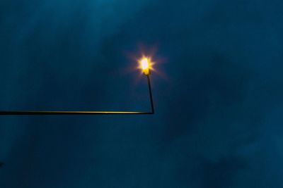 Low angle view of illuminated street light at night