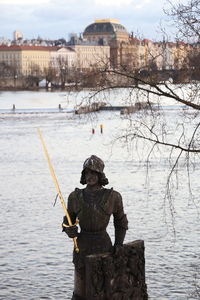 Rear view of man standing on puddle