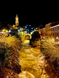 Illuminated buildings in city at night