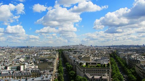 High angle shot of cityscape against cloudy sky