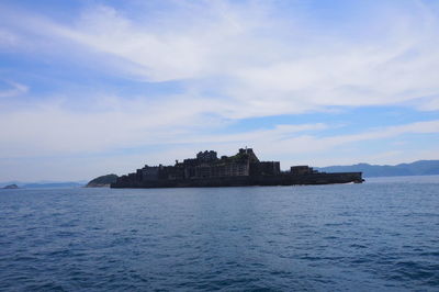 Scenic view of sea and buildings against sky