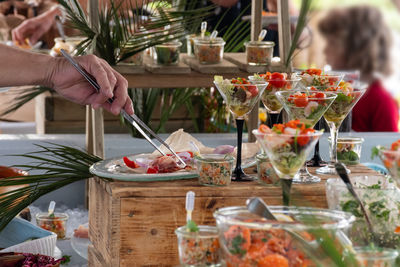 Midsection of woman holding food on table