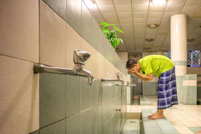 Man washing face in bathroom