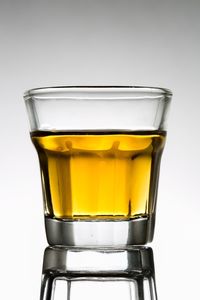 Close-up of beer glass against white background