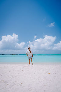 Man standing on beach against sky