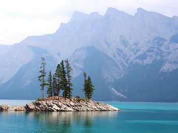 Scenic view of sea and mountains against sky