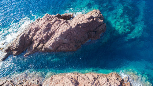High angle view of rock formations in sea