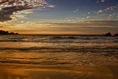 Scenic view of beach at sunset