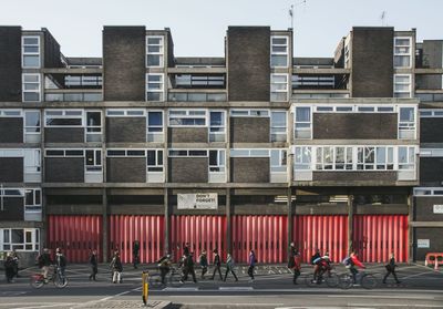 People walking on street against building