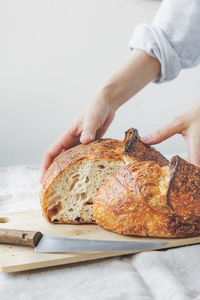 Cropped hand of person preparing food on table