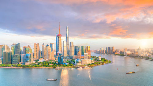 View of buildings against cloudy sky during sunset