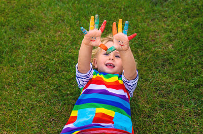 High angle view of boy playing with toys on grassy field
