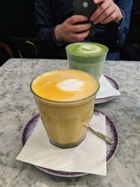 Midsection of coffee cup on table