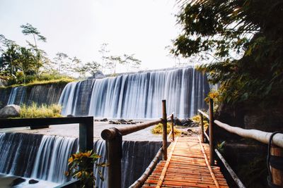 Scenic view of waterfall against sky