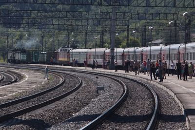  trans-mongolian train passengers and carriages on curving railway platform 