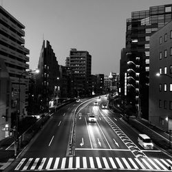 City street and buildings against clear sky