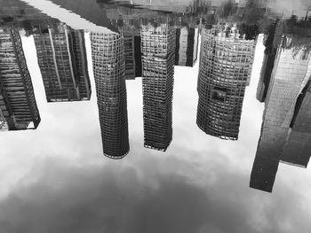 Building reflected on a pond at la mexicana park in santa fe, mexico city.