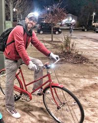 Man riding bicycle on street in city