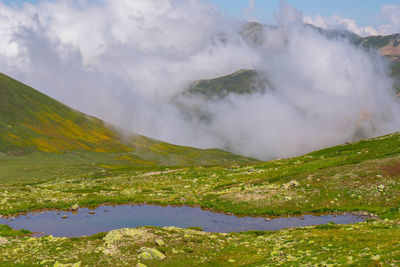 Scenic view of waterfall against sky