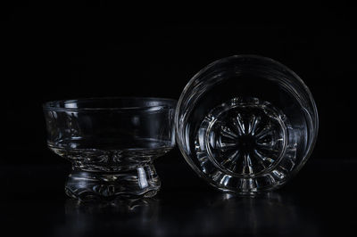 Close-up of glass bowls against black background