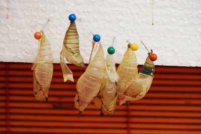 Close-up of multi colored umbrellas hanging on table