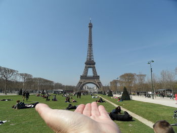 Midsection of person tower against sky in city