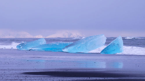 Scenic view of sea against sky during winter