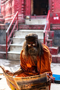 Rear view of a man sitting on temple