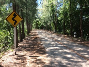 Road sign by trees