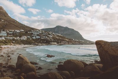 Scenic view of sea and mountains against sky