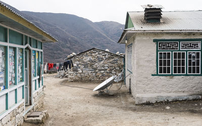 Houses in village against clear sky