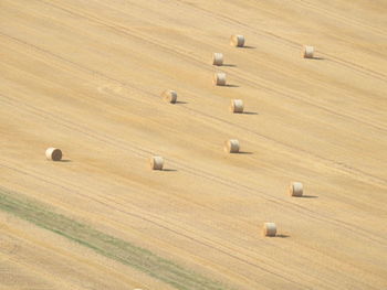 High angle view of hay bales on field