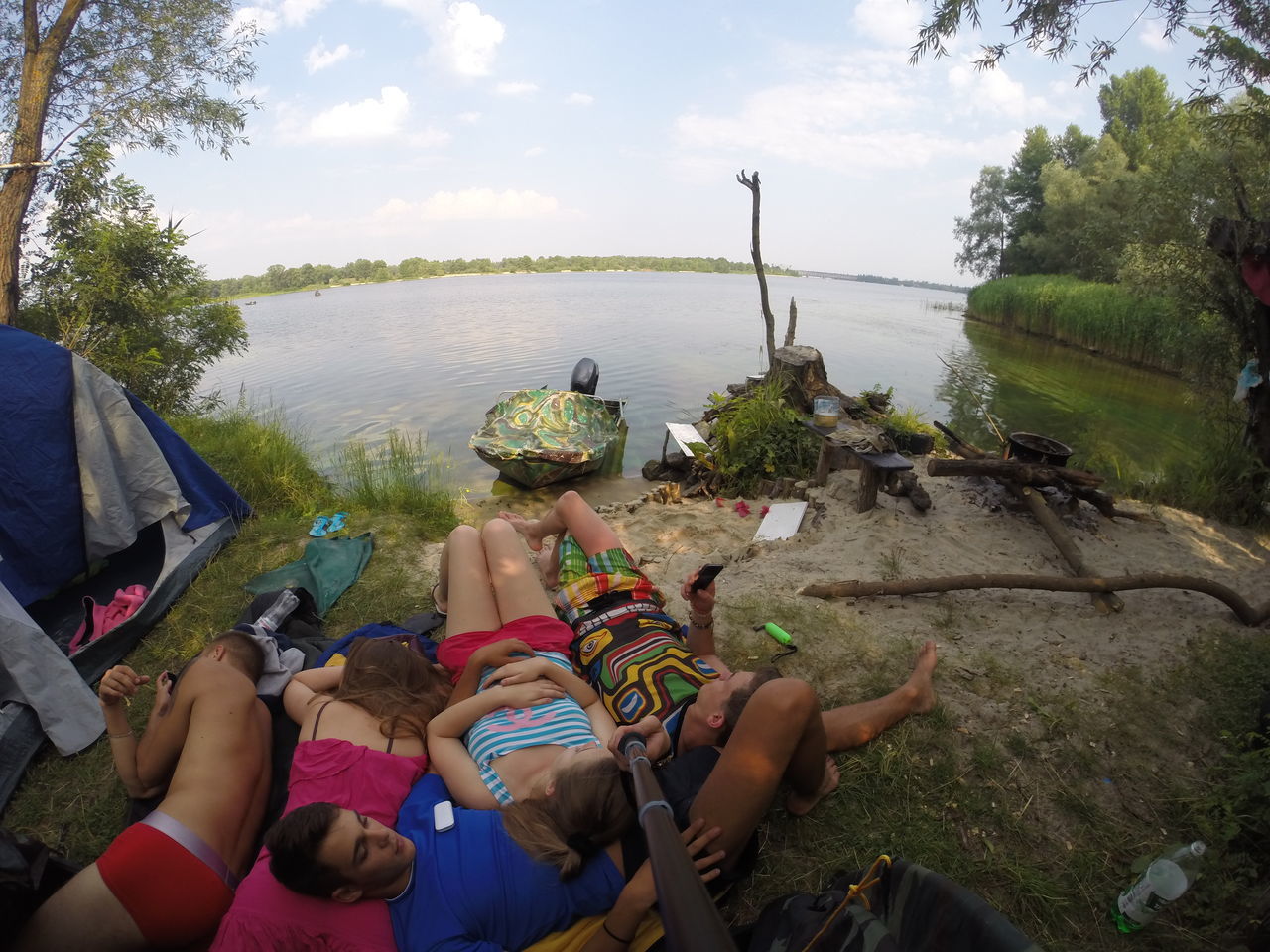 water, lifestyles, leisure activity, tree, sky, men, nature, lake, person, river, sitting, nautical vessel, vacations, cloud - sky, tranquility, day, outdoors