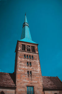 Low angle view of bell tower against blue sky