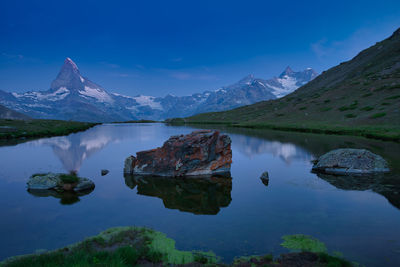 Scenic view of lake and mountains against sky