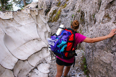 Rear view of woman standing on rock